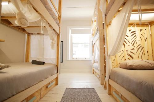 a bedroom with two bunk beds and a window at MOY Guesthouse & Backpackers in Cape Town