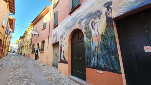 an alley with a painting on the side of a building at Locanda Dolcevita in Dozza