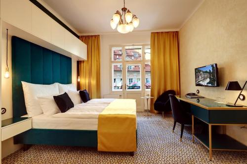 a hotel room with a bed and a desk at Art Deco WOLKER by ASTORIA Hotel & Medical Spa in Karlovy Vary
