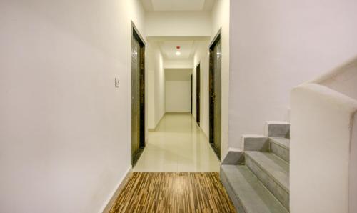 a hallway with stairs and a rug on the floor at Treebo Kings Inn Vashi in Mumbai