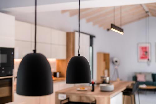 two black pendant lights hanging in a kitchen at Swedish-Style Villa Salz in Fiskardho