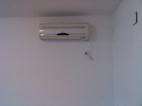 a air conditioner on a wall in a room at Apartmani Stojanović in Sutomore