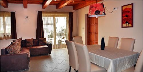 a living room with a table and a couch at Centrum Vendégház in Tihany