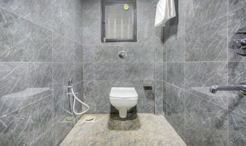 a bathroom with a toilet and a shower at Treebo Kings Inn Vashi in Mumbai