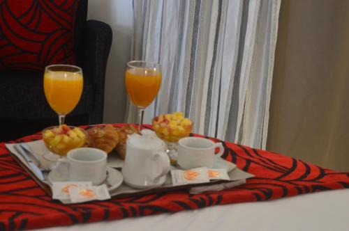 a tray of food and two glasses of orange juice at Prestige Hotel & Spa in Tetouan