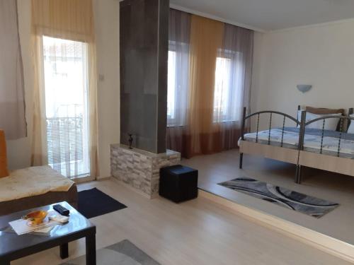 a living room with two bunk beds and a fireplace at Alex Apartments in Kruševo