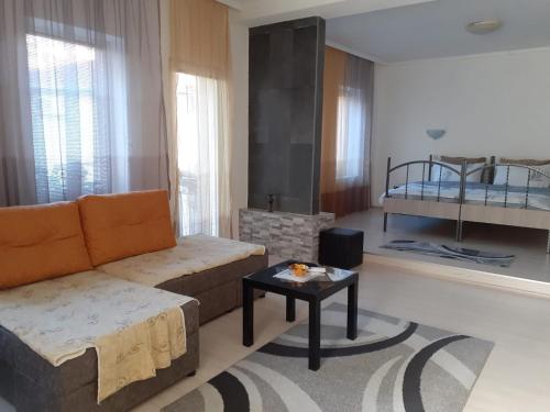 a living room with a couch and a bed at Alex Apartments in Kruševo
