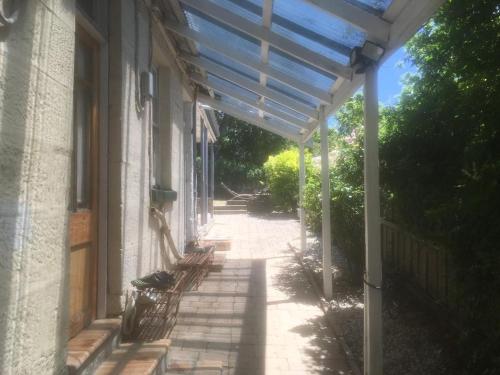 a patio with benches and awning on a building at Hobart Colonial Apartment in Hobart