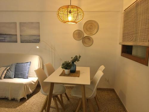 a room with a table and chairs and a bed at Edificio Calpemar in Calpe
