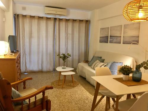 a living room with a couch and a table at Edificio Calpemar in Calpe