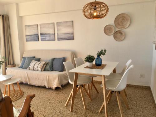a living room with a bed and a table and chairs at Edificio Calpemar in Calpe