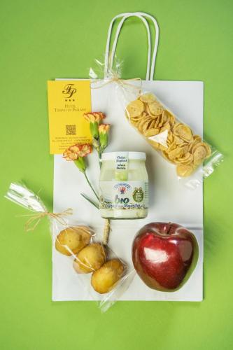 a plate of food with an apple and other snacks at Hotel Tempio Di Pallade in Rome
