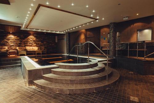 a hot tub in a room with stairs in a building at Holiday Club Åre in Åre