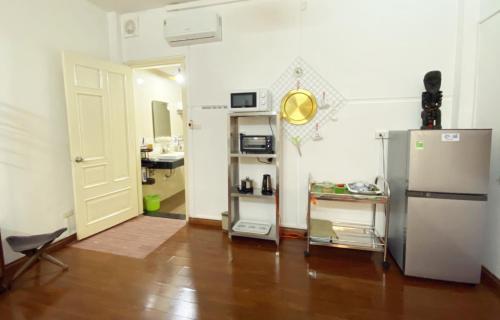 a living room with a refrigerator and a kitchen at Doctor Homestay 2 in Hanoi