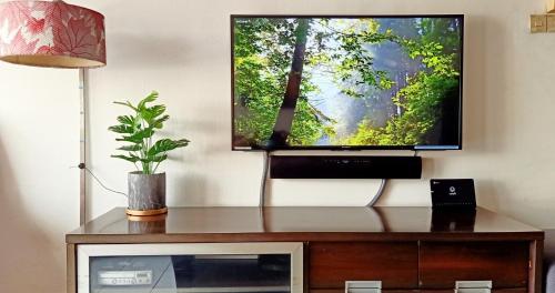 a flat screen tv sitting on top of a entertainment center at Cozy Little Room at Suria Kipark Damansara Apartment with Single Bed and a Foldable Mattress in Kuala Lumpur