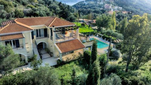 an aerial view of a house with a swimming pool at Spacious 4-Bedroom Villa with Private Pool and Stunning Sunset Views, 3 Minutes from the Beach in Afionas