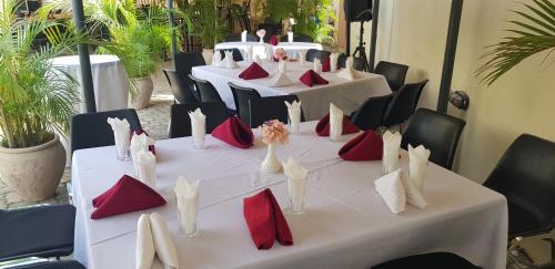 a group of tables with red and white pillows at ShaMooL Hotel in Dar es Salaam