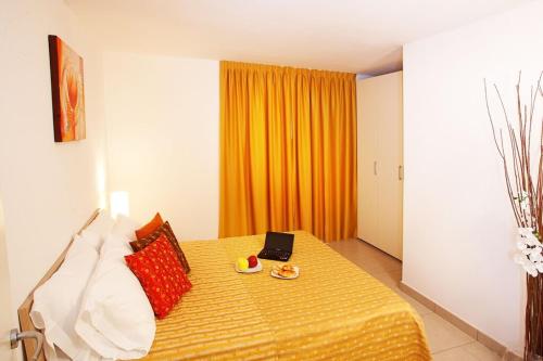 a hotel room with a bed with a laptop on it at Tremezzo Residence 3-1 of 11 apartments in an exclusive residence by Italian Apartments in Tremezzo
