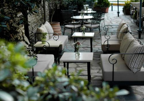 a row of tables and chairs on a patio at Marelia Hotel in Poligiros