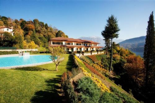 a house on a hill with a swimming pool at Tremezzo Residence 3-1 of 11 apartments in an exclusive residence by Italian Apartments in Tremezzo