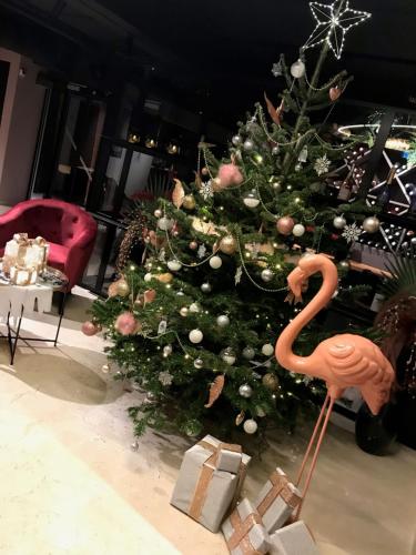 a christmas tree with a flamingo toy in front of it at GOLF HOTEL in La Grande-Motte