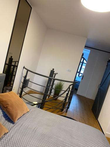 a bedroom with a bed and a stair case at Apartmán Anna in Komárno