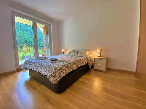a bedroom with a bed and a large window at Ribasol 645, apartamento hasta 4 personas, Arinsal in Arinsal