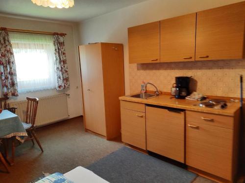 a kitchen with wooden cabinets and a counter top at Haus Betz in Garmisch-Partenkirchen