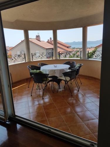 a dining room with a table and chairs on a balcony at Villa Jelena in Zadar