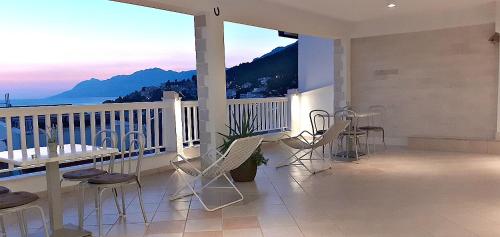 balkon ze stołem i krzesłami oraz widokiem na ocean w obiekcie Apartments Villa Bonaca w Baskiej Vodzie