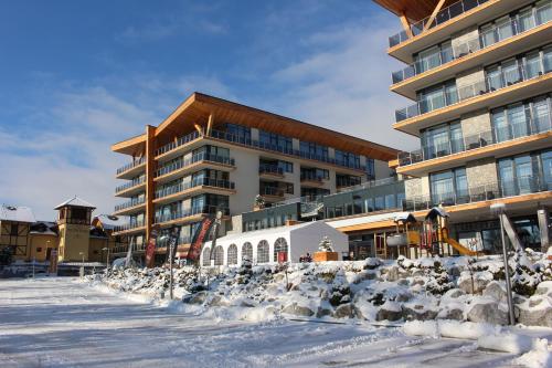 a herd of sheep in front of a building at Apartman Lucid C207 in Smokovce