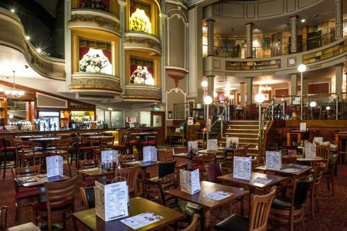 a restaurant with wooden tables and chairs in a room at Nautical Apartment by Seaside Llandudno in Llandudno