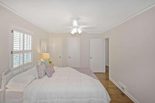 a white bedroom with a bed and a ceiling fan at South Perry St in Lawrenceville