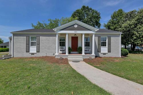 a small white house with a red door at South Perry St in Lawrenceville