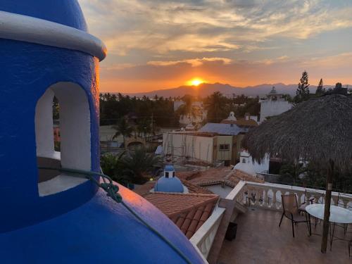 a view of the sunset from a balcony of a house at Aventura Pacifico Boutique Suites & Villas in Bucerías