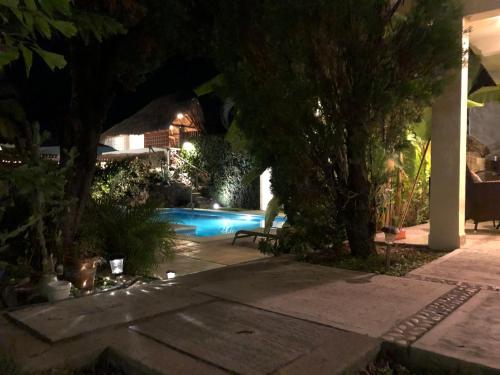 a backyard at night with a swimming pool at Aventura Pacifico Boutique Suites & Villas in Bucerías