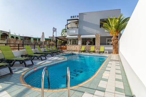 a swimming pool with chairs and a hotel at ICandy Sol in Malia