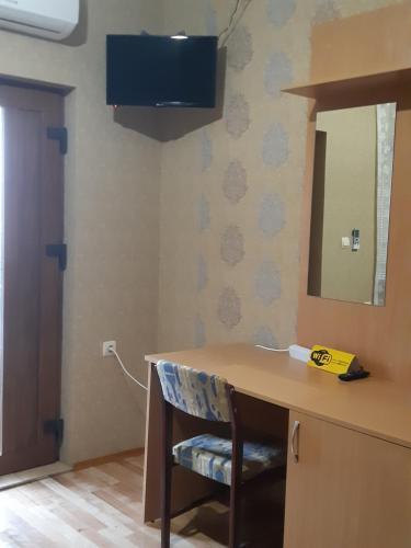 a small room with a television and a sink at Zlata Praha in Mukacheve