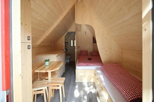 a room with a bed and a table in a room at Glamping Heidekamp in Versmold