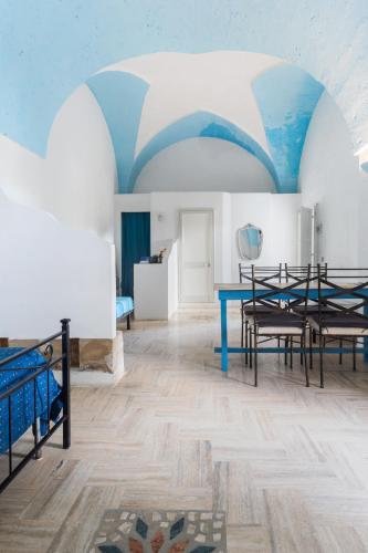 a room with a blue table and chairs at Masseria Tornesella Don Giuliano in Parabita