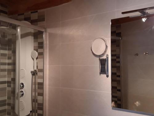 a bathroom with a shower with a mirror at Casa rural La tía María in Pereruela