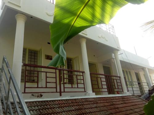 a building with a large green flag in front of it at Coconut Grove in Cochin