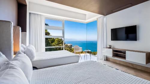 a bedroom with two beds and a large window at Avalon - 401 Luxury & Breathtaking Sunset Views in Puerto Vallarta
