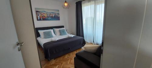 a small bedroom with a bed and a mirror at Holiday home Velebit in Nin