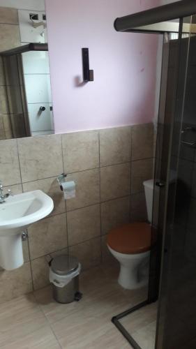 uma casa de banho com um WC e um lavatório em The House Pousada e Hospedagem Enseada- Guarujá no Guarujá