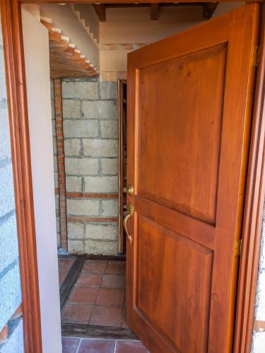 an open door to a room with a brick wall at Hotel San Buenaventura de Atitlán in Panajachel