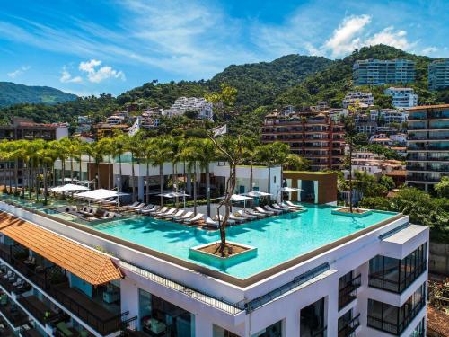 a hotel with a pool on top of a building at PIER 57 - 711 Fabulous & Dreamy 1 BR Romantic Zone in Puerto Vallarta