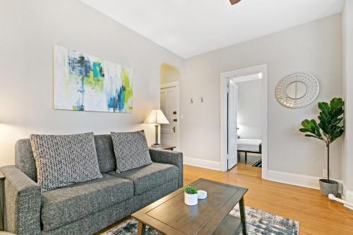 a living room with a couch and a table at Comfy 2BR Apartment near Wrigley Field - Grace 3 in Chicago