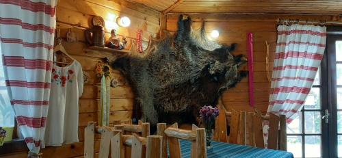 a large bear hanging on the wall of a cabin at Готель Колиба Колорит in Tatariv