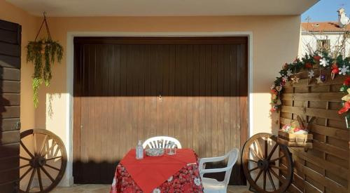 a garage door with a table and chairs in front of it at Montegrappa Fly on in Crespano del Grappa